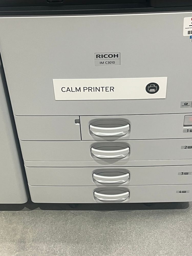 A printer. It has a sticker that says “calm printer” on it. 