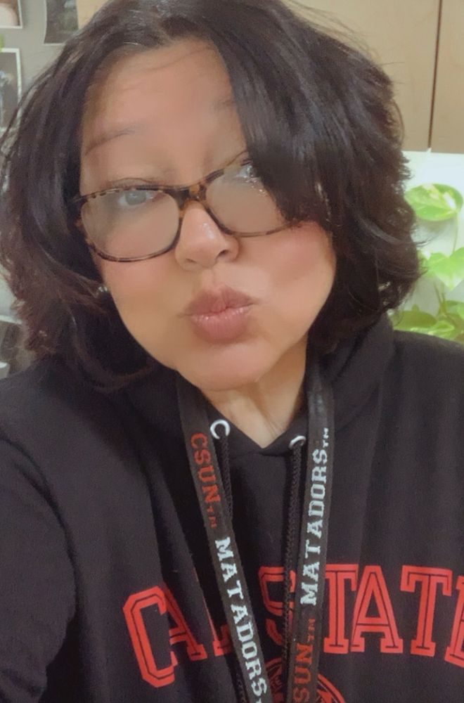Ti, brunette with glasses wearing her work lanyard and university merch. Feeling sassy and rebellious.  