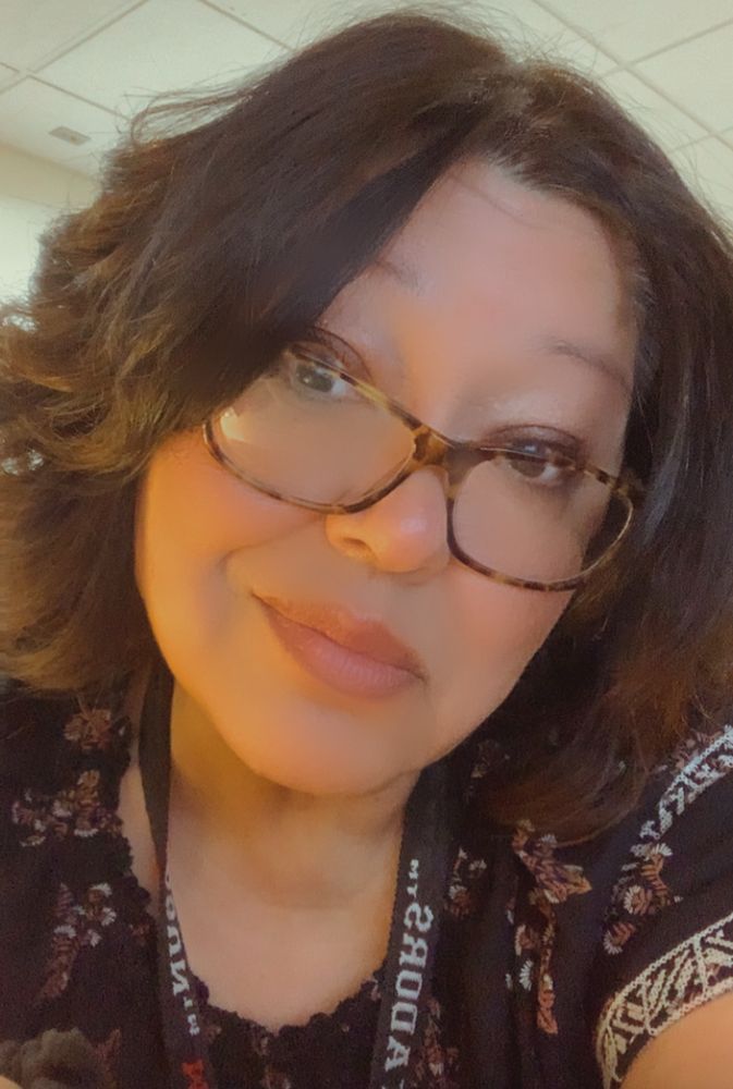 Ti, brunette with glasses wearing a lanyard at work. Kind of not impressed. 