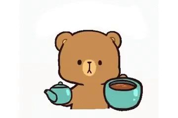 a brown teddy bear is drinking from a blue cup