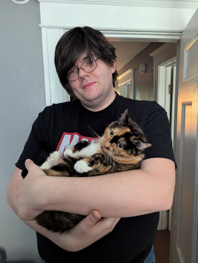 Rook holding the chunky tortoiseshell Marzipan in its arms