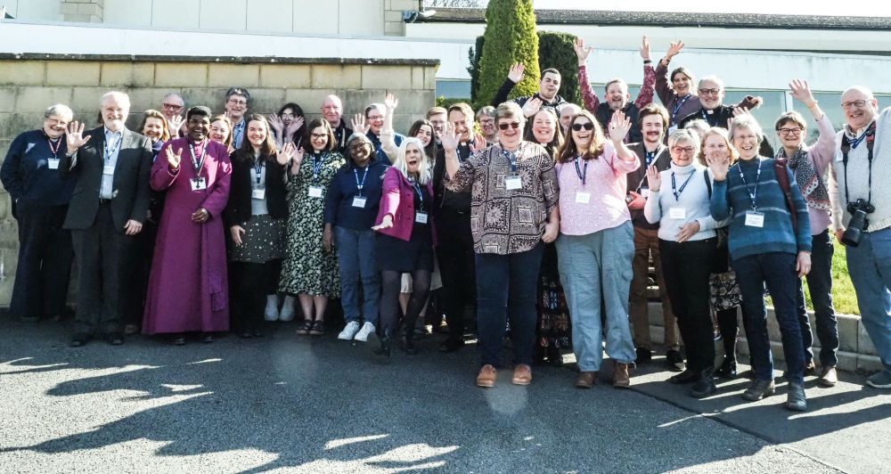 A group of people standing outside a conference centre