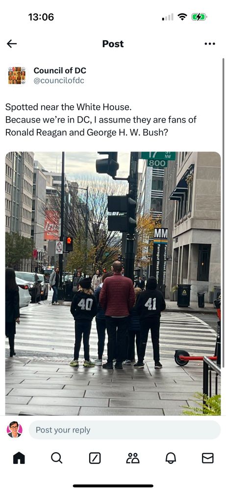 Screenshot of a tweet by @councilofdc showing people standing on sidewalks near Farragut West Station wearing sweatshirts with the numbers 40 and 41 respectively. The text of the tweet is:

“Spotted near the White House. 
Because we’re in DC, I assume they are fans of Ronald Reagan and George H. W. Bush?”
