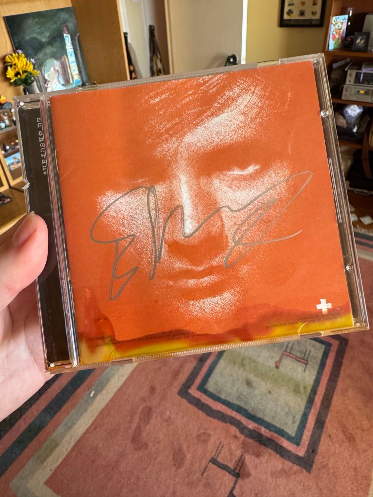 Ed Sheeran CD with visible liquid damage at bottom