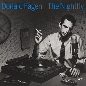 Album cover -- Donald Fagen's "The Nightfly." In a radio studio, a white, brown haired, middle-age man sits holding a cigarette with a vintage radio microphone and turntable in front of him. On the wall are a clipboard and a clock reading about 4:09.