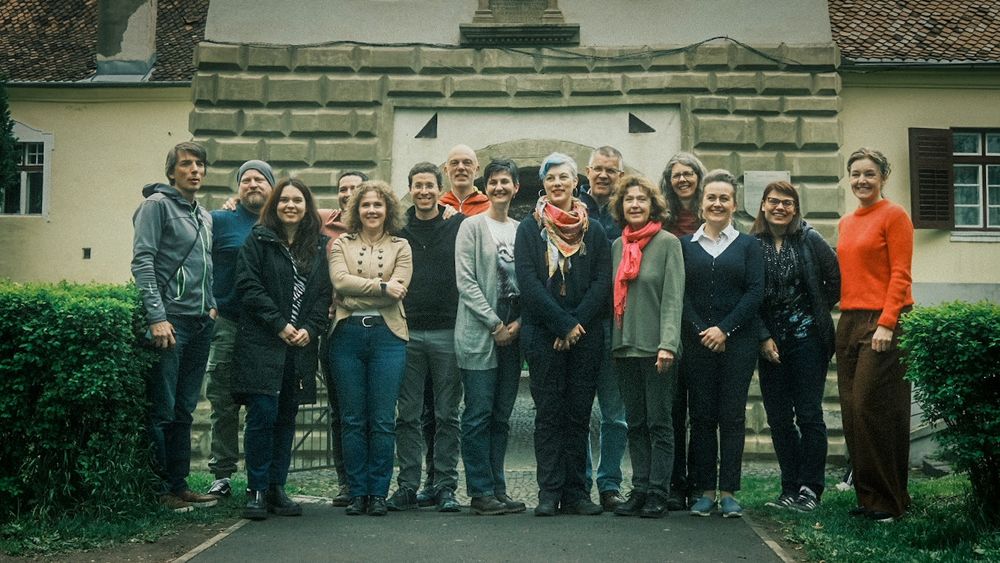 Group photo of scientists in front of old building