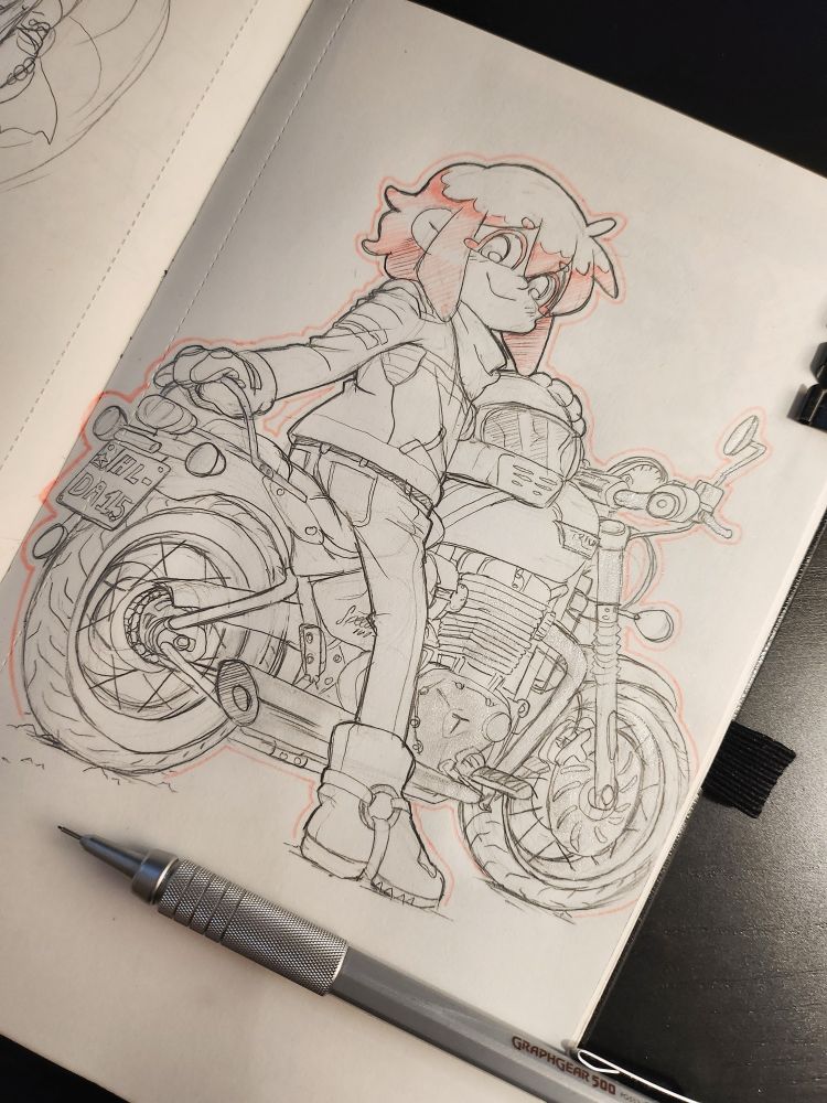 Photo of an open sketchbook. A pink haired girl in retro motorcycle gear is sitting on her old school style motorcycle, looking backwards at the camera.