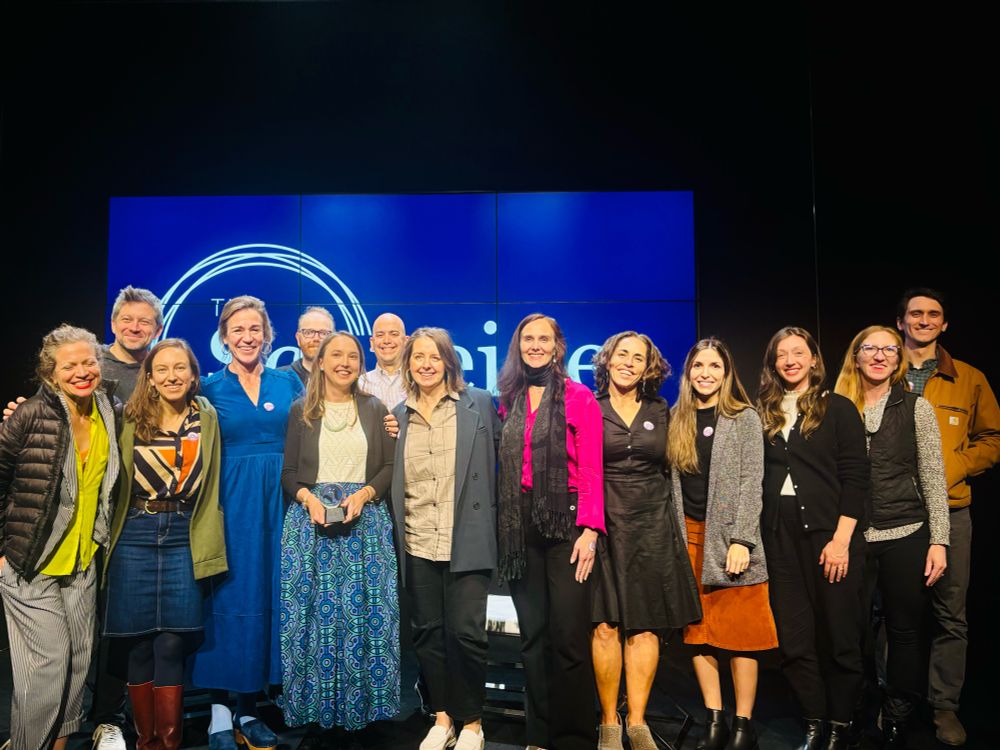 Staff of Rewiring America on stage with Dr Leah Stokes, recipient of the 2024 Stephen Schneider Award for Outstanding Climate Science Communication