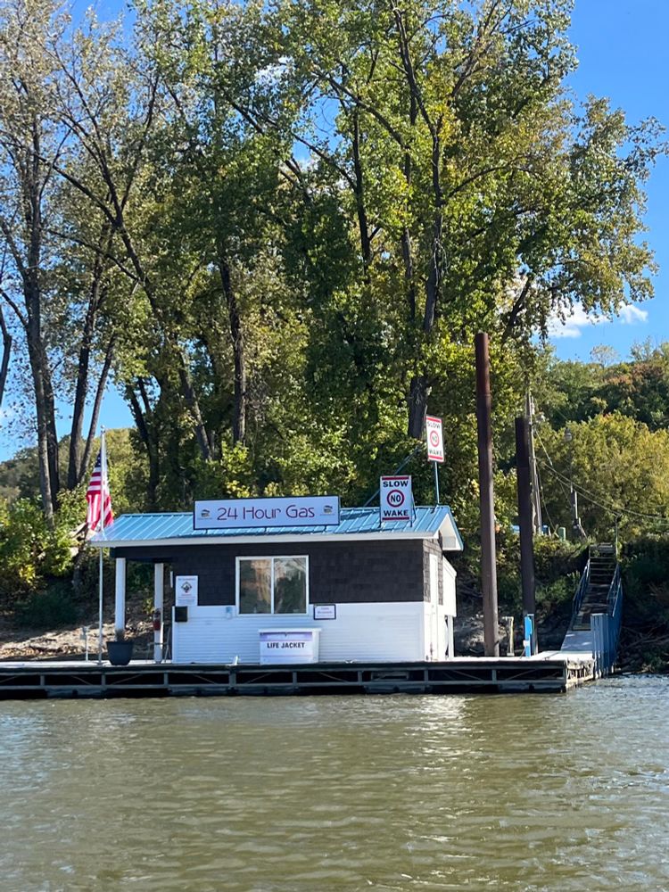 Gas station on the riverfront that reads “24 Hour Gas”