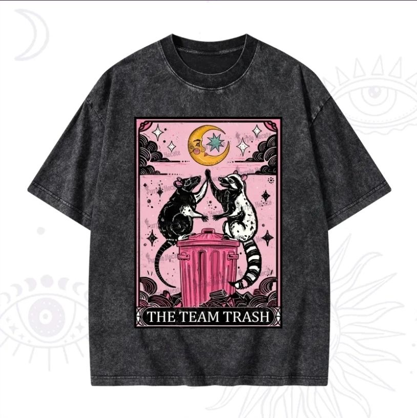 A black shirt depicting a possum and a racoon uniting atop a trash can.
