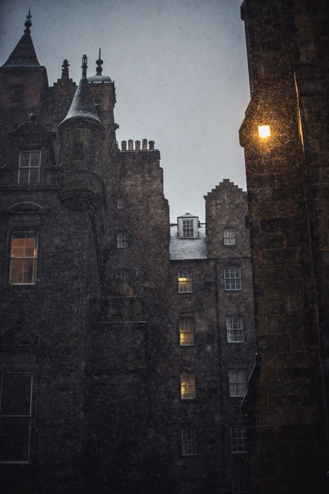 Snow falling in front of Edinburgh's old town