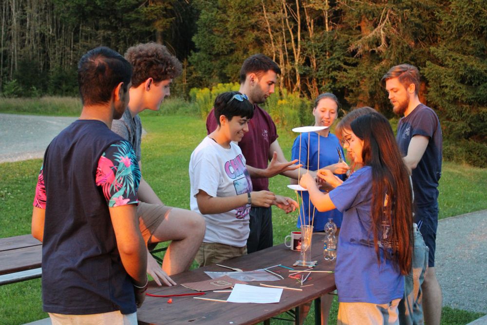 Participants around picnic table building something