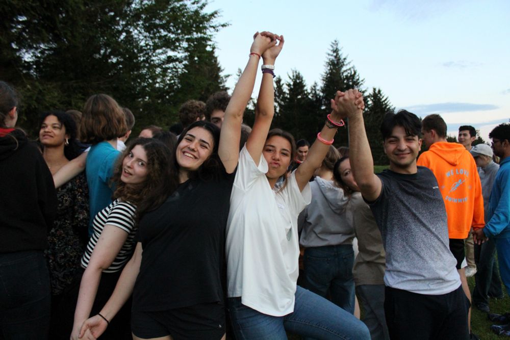 Participants holding hands up for camera