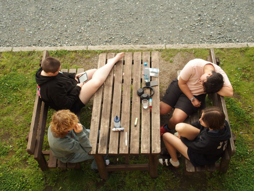 Participants around picnic table chatting 