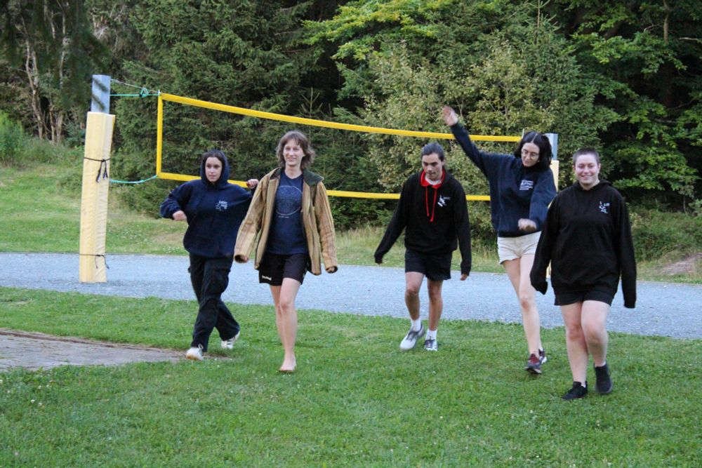 People walking away from volleyball court