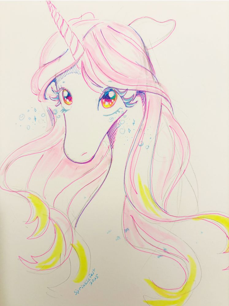 A mixed media sketch of a unicorn in a sketchbook. Unicorn has rainbow eyes with blue tears and has a pink and yellow mane. The sketch at the bottom says Sprinklefest 2025. 