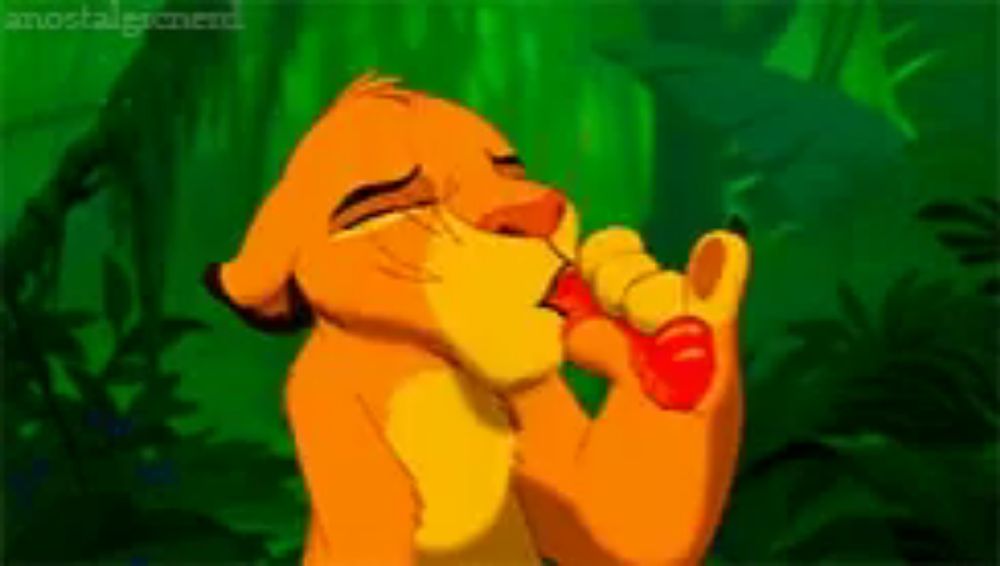 a lion from the lion king is drinking from a red cup .