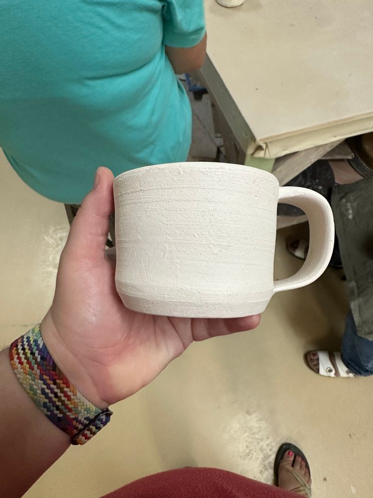 A small clay mug, unglazed