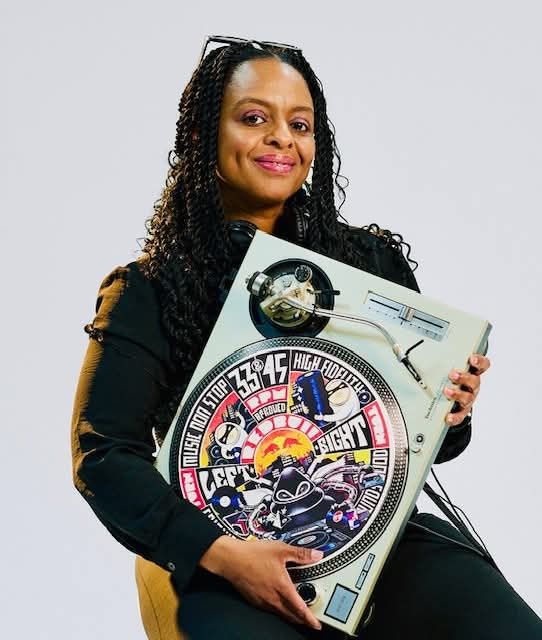 DJ Apryl Reign holding a turntable