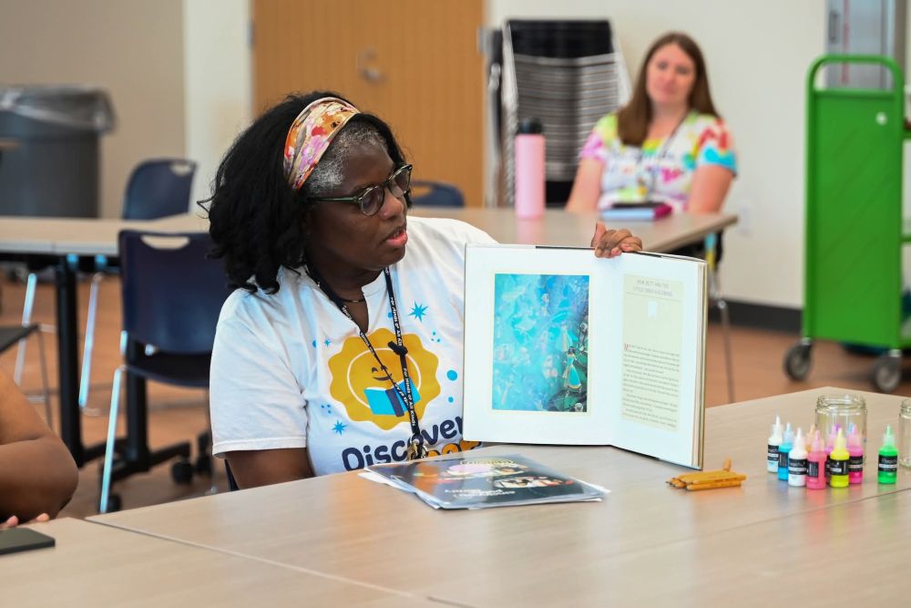 Renee Tecco reads to students during  the Afrofuturism Freedom School workshop on Black mythology and folklore on June 17 