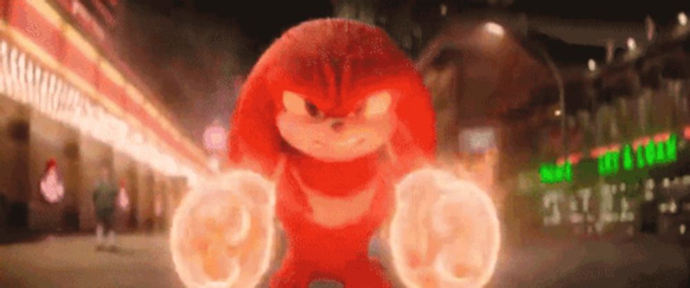 knuckles the echidna from the movie sonic the hedgehog is standing on a city street .