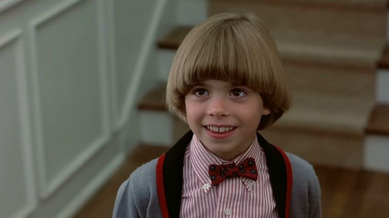 Matthew Lawrence with a bowl cut and bow tie in Planes, Trains, and Automobiles