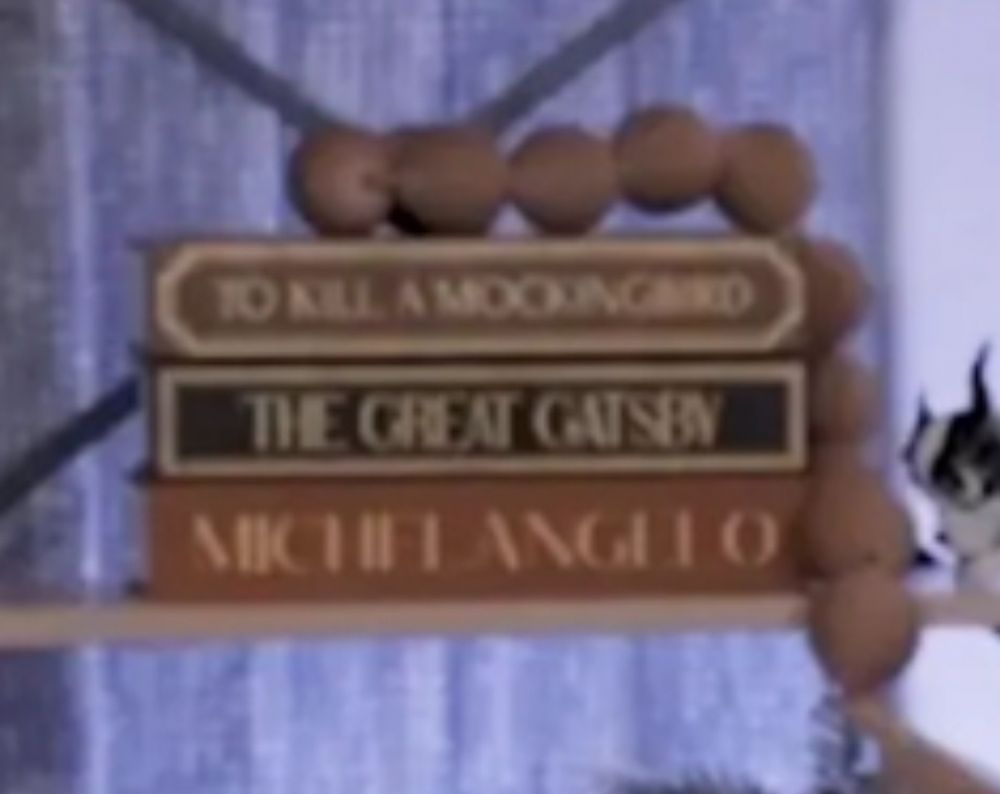 Fake books with a string of brown balls on top