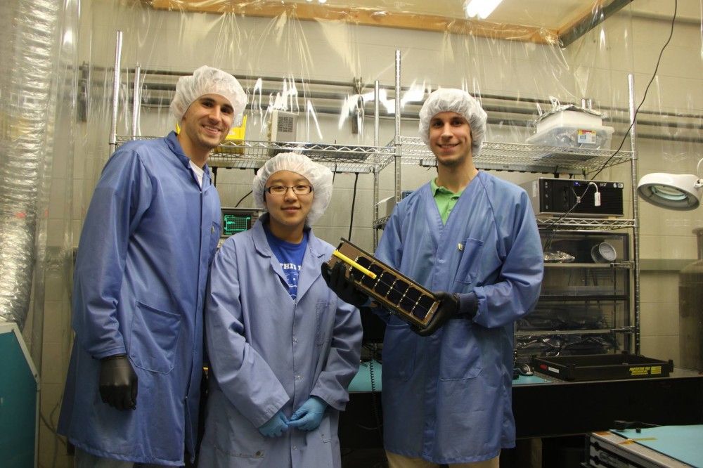Tyler, So-Hee, and Charlie hold the GRIFEX CubeSat.