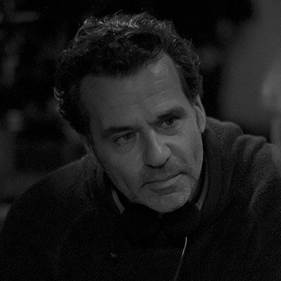 A black-and-white image of a man looking intently at something off-camera.