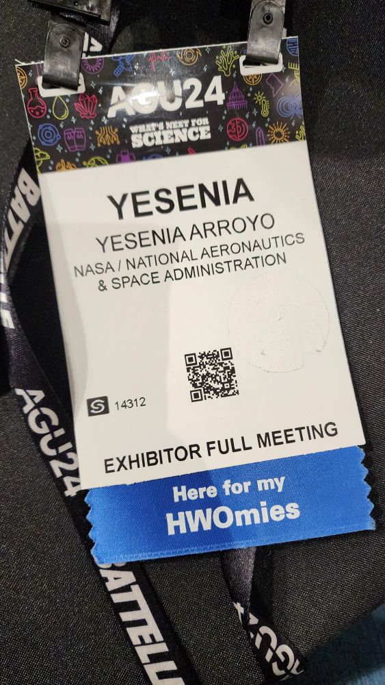 A name badge from AGU 2024 with a ribbon that says "here for my HWOmies"