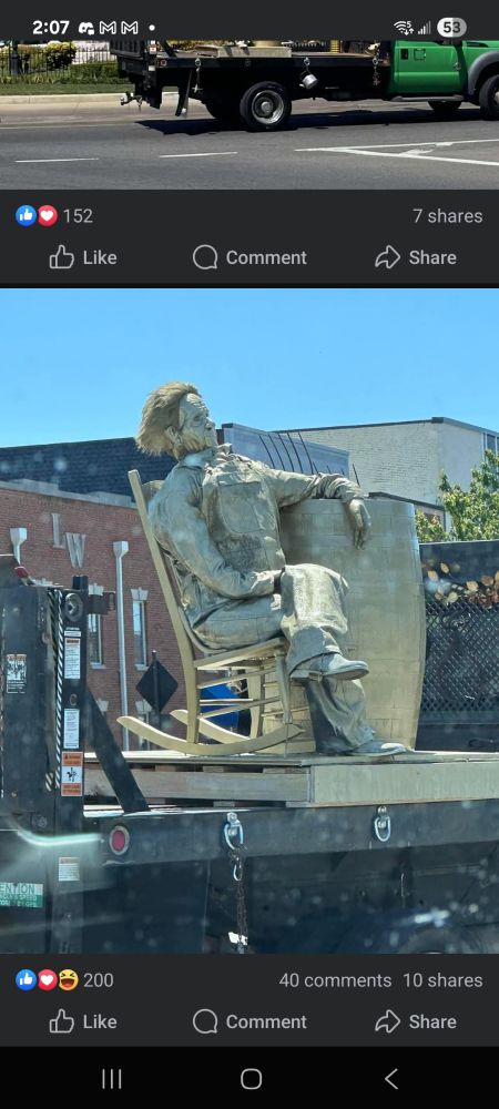 Poor quality Uncle Herschel statue in a chair on a flat truck bed. And by poor quality, I mean something between the undead and Michael Myers