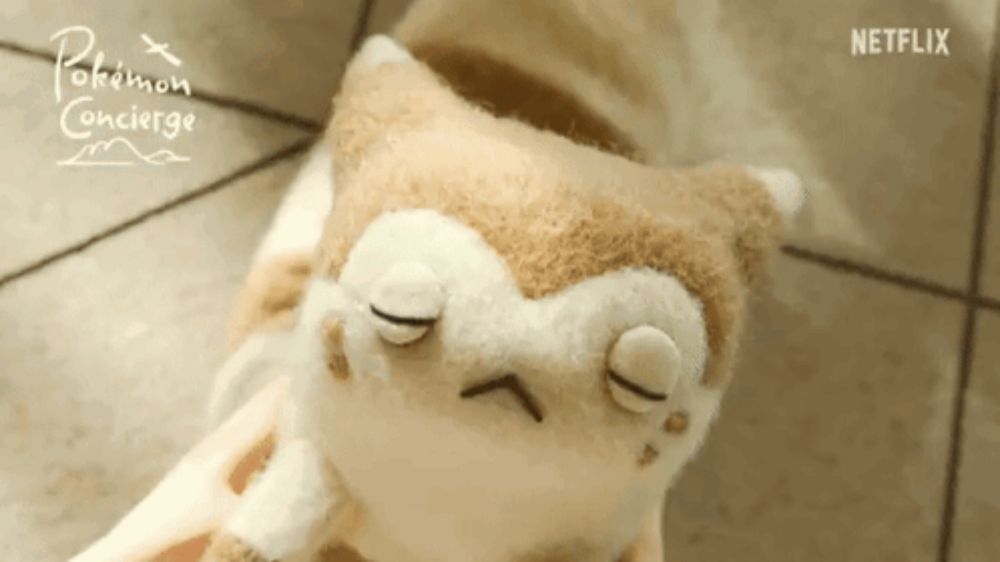 a stuffed animal with a pokemon concierge logo on the bottom