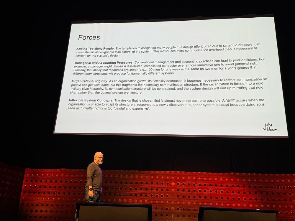 Jabe walking through the stage in front of Herbert Simon PhD paper