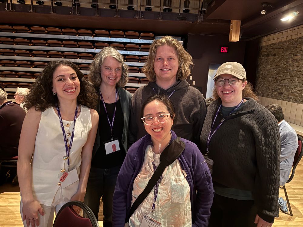 Group of five people at a conference 