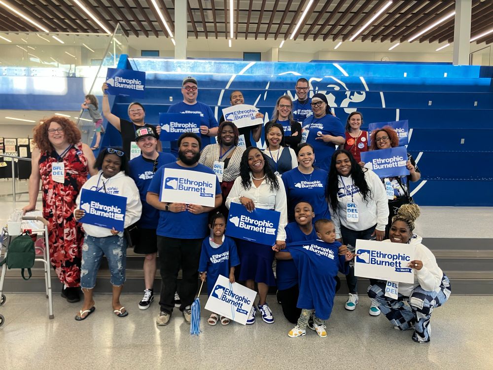 A group of supporters holding Ethrophic Burnett for Ward 5 signs