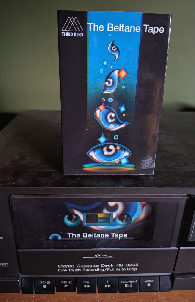 A photo of a cassette box sitting on a tape deck