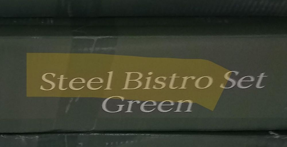 Close-up of packaging labelled "Steel Bistro Set Green" with the words "Steel Bistro" highlighted.