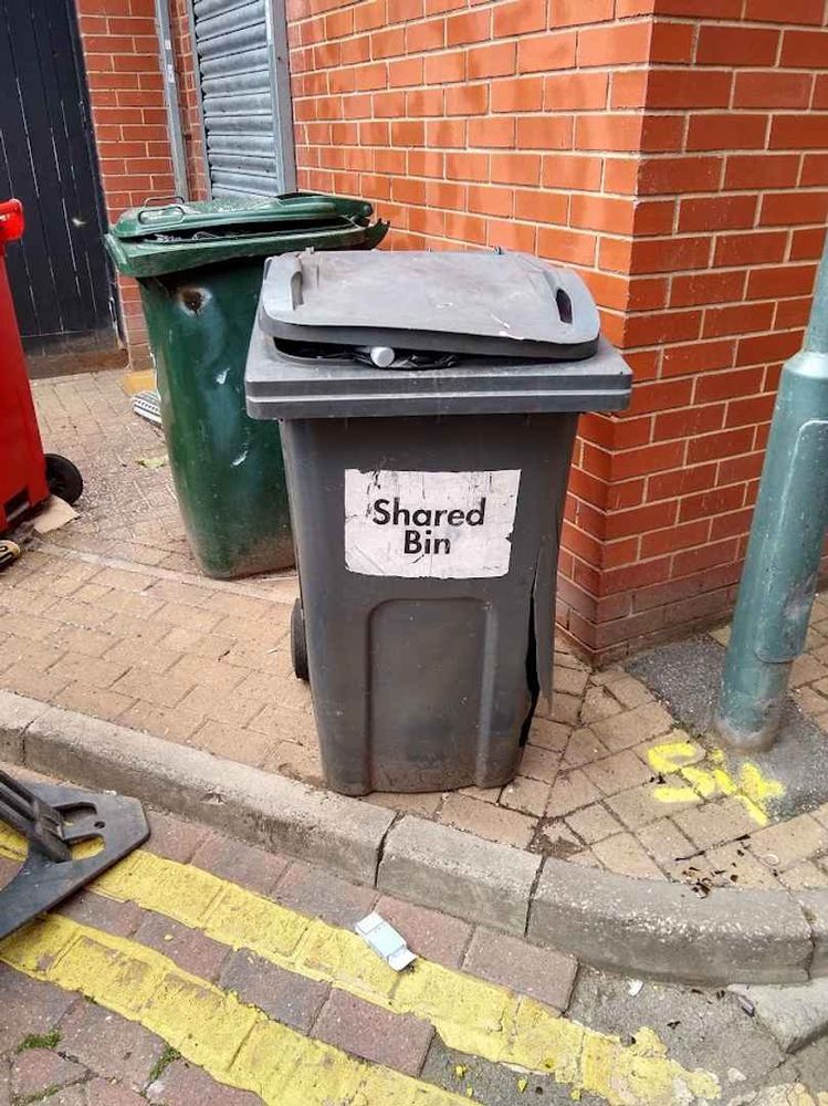 A "wheely bin" prominently labelled "shared bin..."