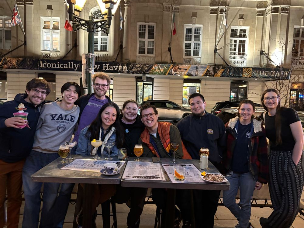 A group of people celebrating with drinks outside of a bar in New Haven, Connecticut.