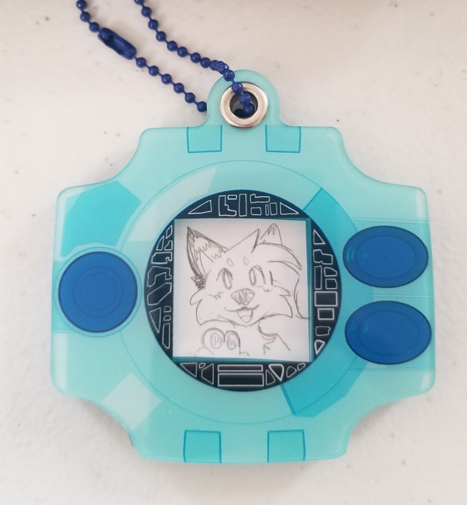 Digivice keychain photo holder with a pencil sketch of a character inside it