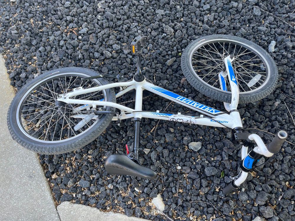A small specialized hotrock kid’s bike. White with blue