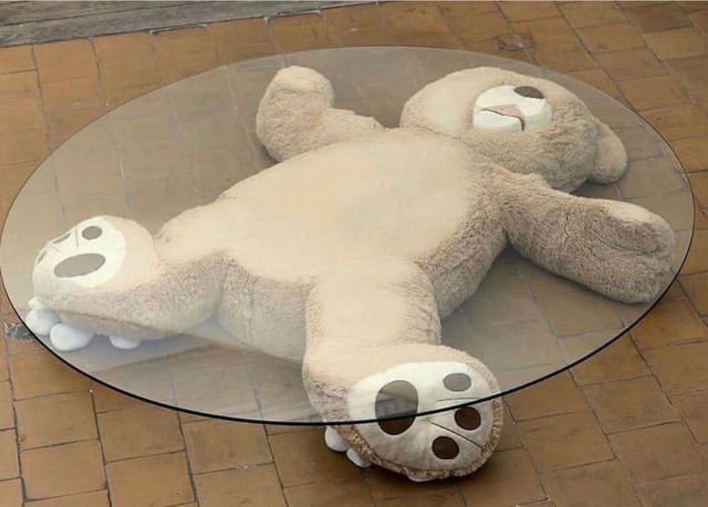 Fuzzy bear crushed under glass table