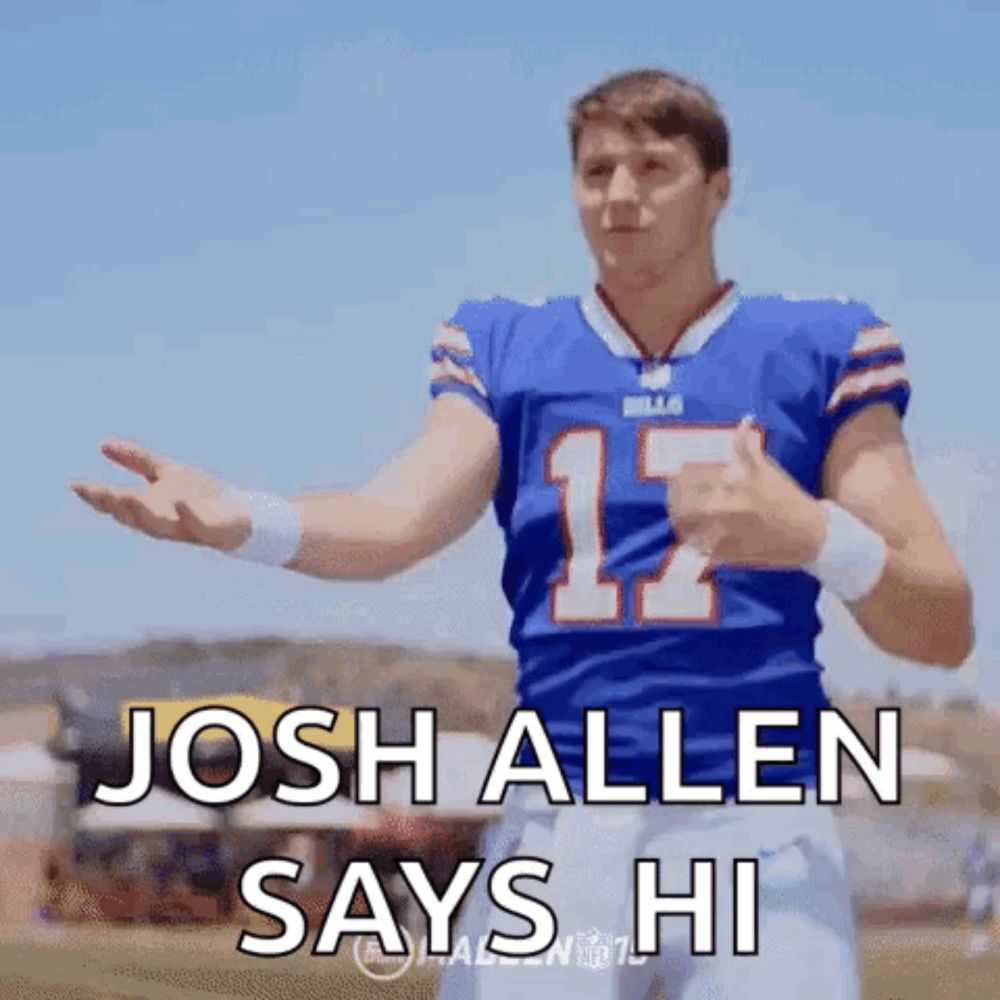 a football player in a blue jersey with the number 12 on it is giving a thumbs up .