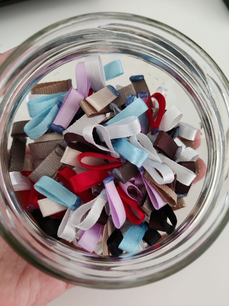 A jar full of ribbon loops.