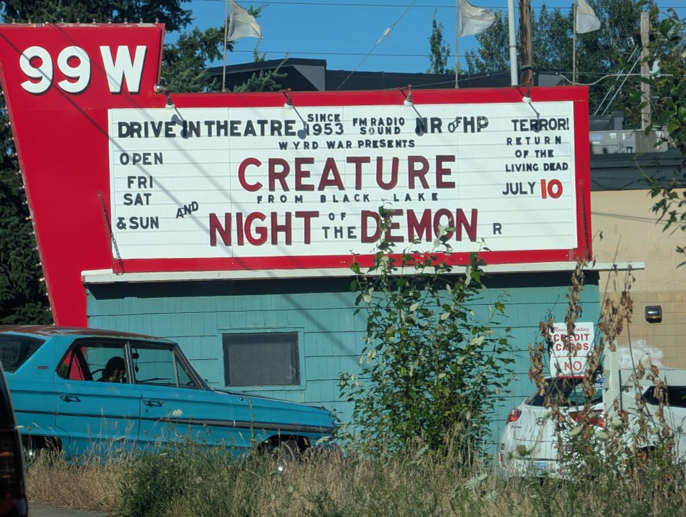 A marquee for the 99w Drive In announcing the double feature of CREATURE FROM BLACK LAKE and NIGHT OF THE DEMON. 
