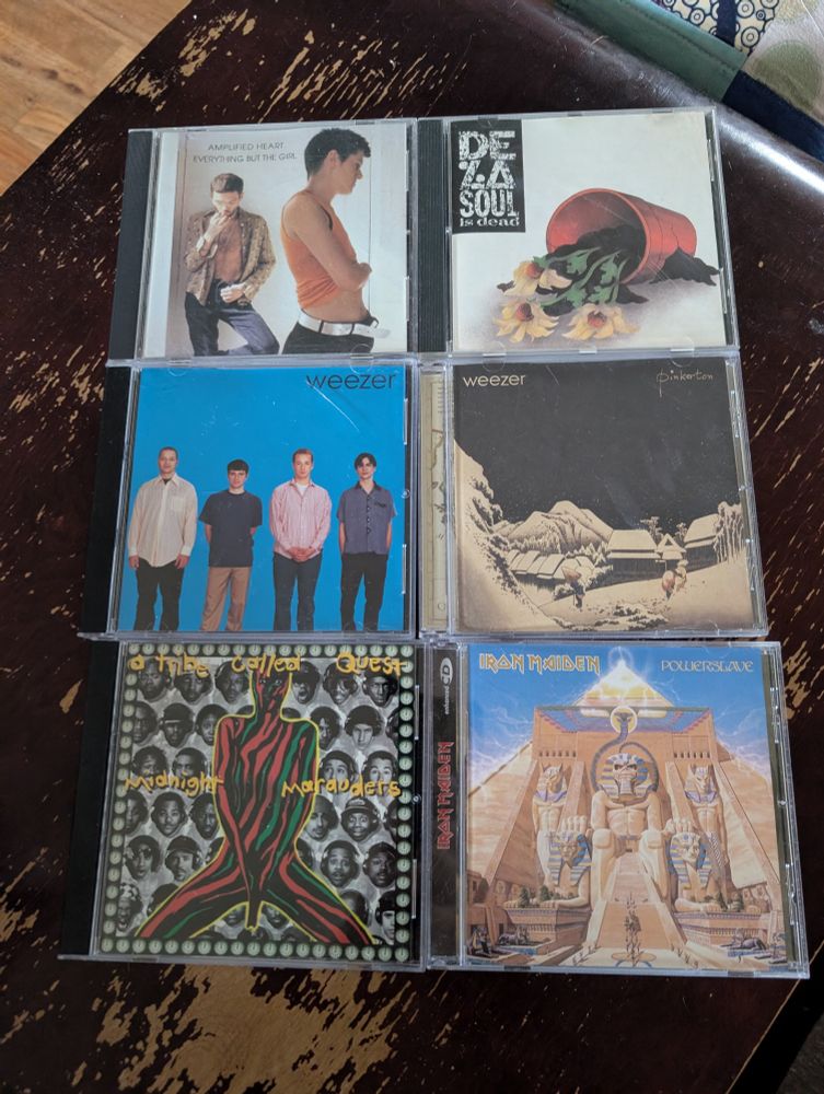 CDs by Everything But The Girl, De La Soul, Weezer, A Tribe Called Quest, and Iron Maiden