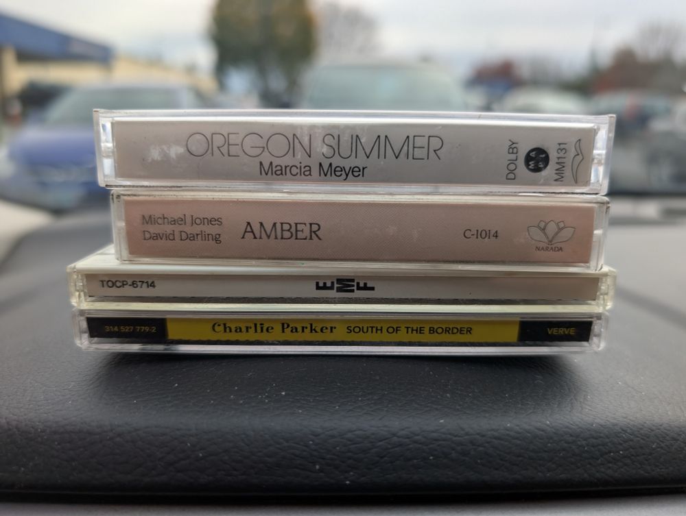 Cassettes by Marcia Meyer and Michael Jones w/ David Darling and CDs by EMF and Charlie Parker