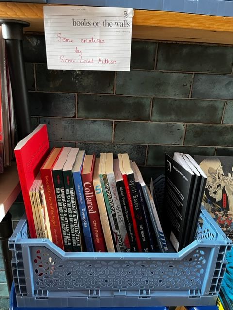 Crate of books at Books on the Walls in Chester, showcasing local authors