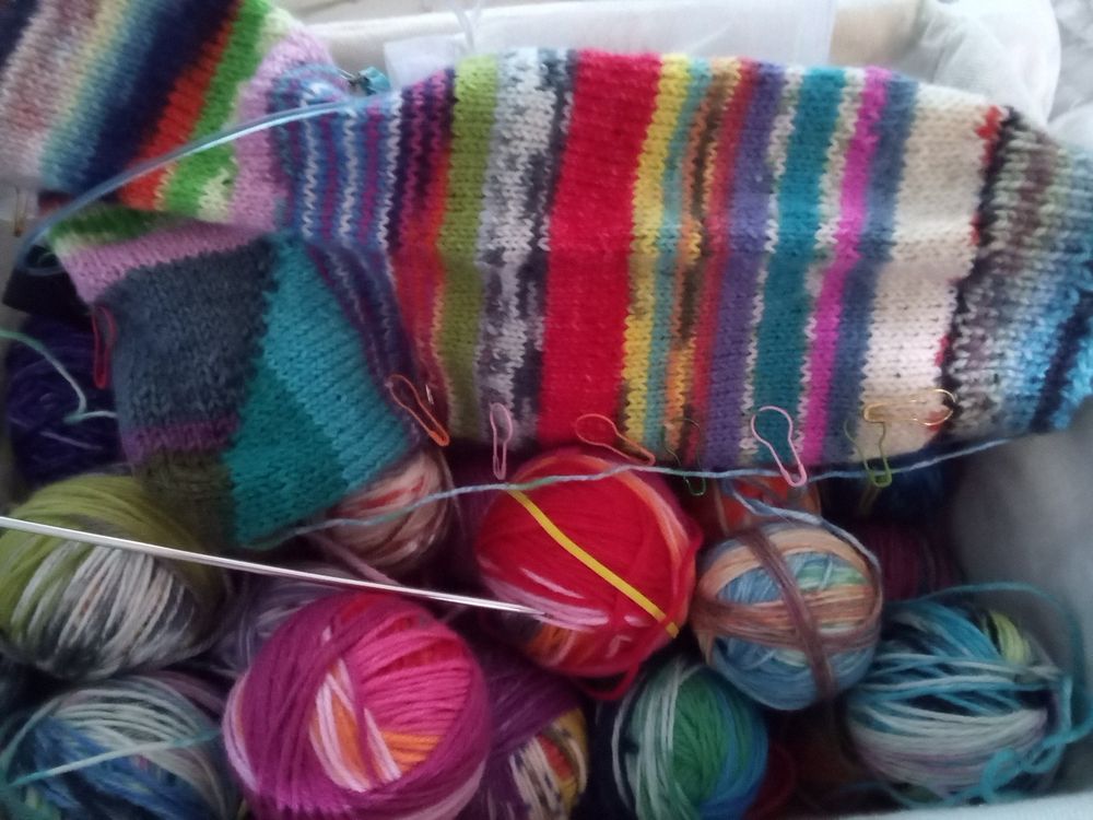 Socks knit with small bits and bobs of leftover fingering weight yarns. Colorful and mismatched.