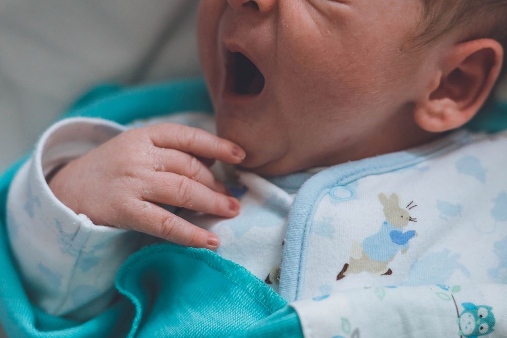 Image of a newborn baby yawning